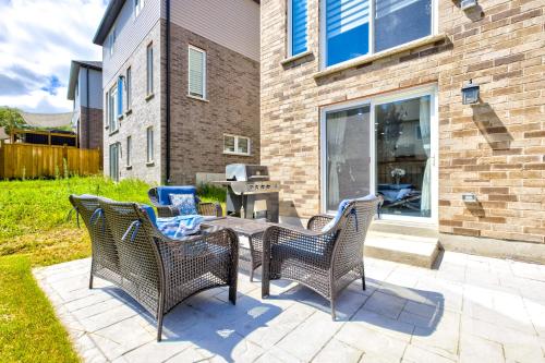a patio with wicker chairs and a table at New Furnished 1bedroom basement in Waterloo