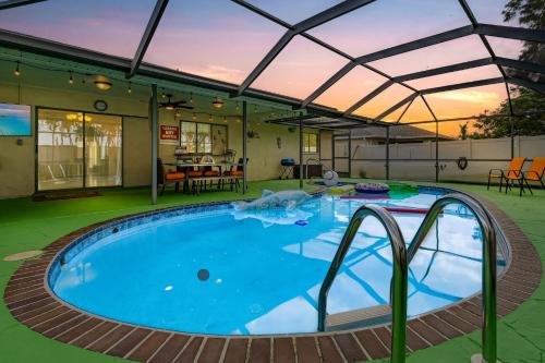 a large swimming pool with a retractable roof at Green Oasis Retreat in Cape Coral