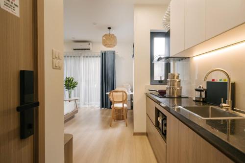 a kitchen with a sink and a counter top at Lux Apartment Ngọc Khánh 2 in Hanoi