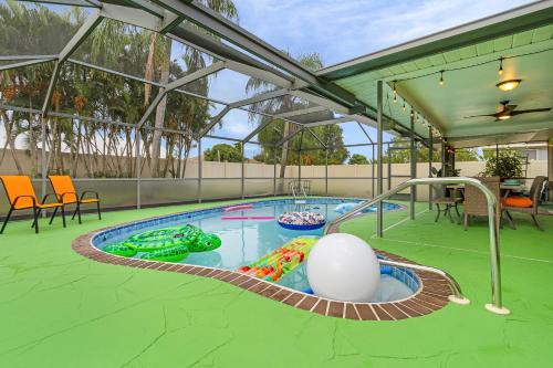a swimming pool with a inflatable turtle in it at Green Oasis Retreat in Cape Coral
