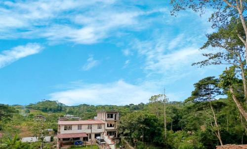 a house in the forest with a blue sky at Casa la Estancia 2 in Tena