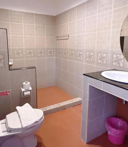 a bathroom with a toilet and a sink at Phiphu Art and Gallery Boutique Sukhothai in Sukhothai