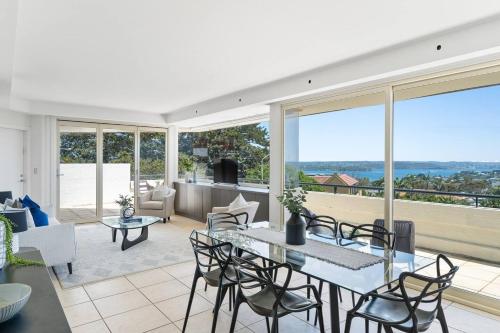 a living room with a table and chairs at South Head - Premier Penthouse w Amazing Views in Sydney