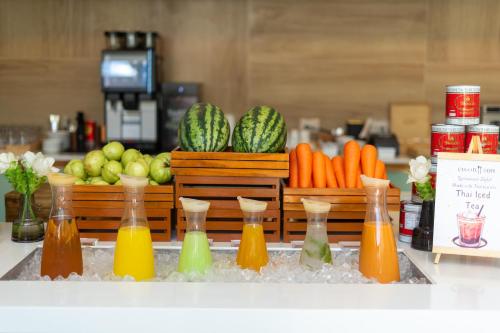 a group of bottles filled with different colored liquids at Courtyard by Marriott Bangkok Suvarnabhumi Airport in Lat Krabang