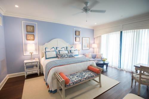 a bedroom with a large bed with blue walls at The Beach Club at Charleston Harbor Resort and Marina in Charleston