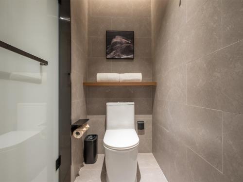 a bathroom with a white toilet in a room at Atour Hotel Shenzhen Nanshan Mango Building in Shenzhen