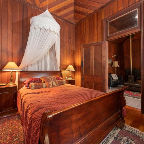 a bedroom with a large bed with a canopy at Stanthorpe Heritage Estate in Dalveen