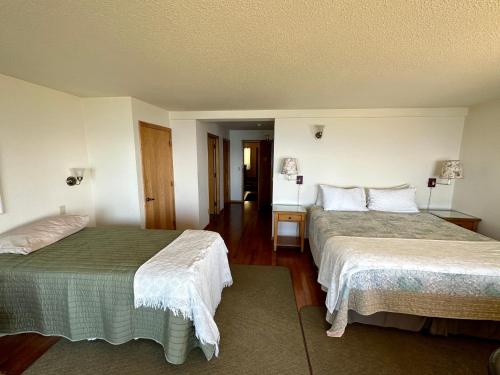 a hotel room with two beds in a room at Turtle Rocks Oceanfront Inn in Trinidad