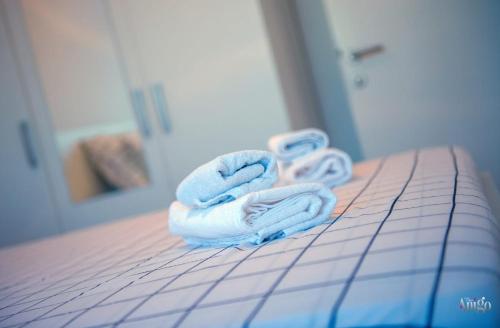 a pair of towels sitting on top of a bed at Apartman Mary in Široki Brijeg