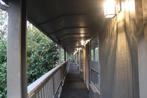 a hallway of a building with awning and plants at Cedarwood Inn of Ashland in Ashland