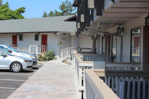 a car parked in a parking lot next to a house at Cedarwood Inn of Ashland in Ashland