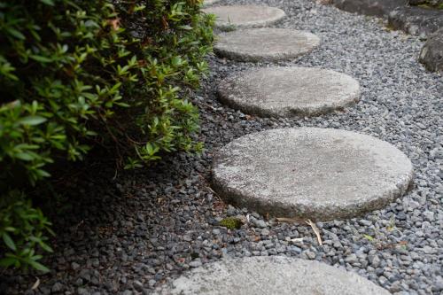 a walkway with stepping stones on the ground at Hanare Yado Yosizumi in Ito