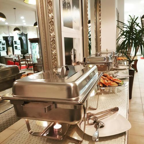 a row of stainless steel sinks in a restaurant at Hotel Villa Valpovo in Valpovo