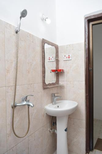 a bathroom with a sink and a shower at Fun City Water & Theme Park in Dar es Salaam
