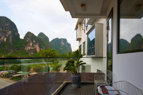a balcony with a view of the mountains at The One Hotel壹心生活美学酒店 in Yangshuo