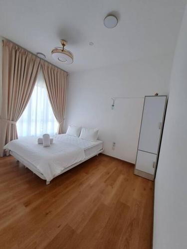 a white bedroom with a bed and a mirror at AirHomestay Ostia Bangi Pool & Sunset view Wifi in Bandar Baru Bangi