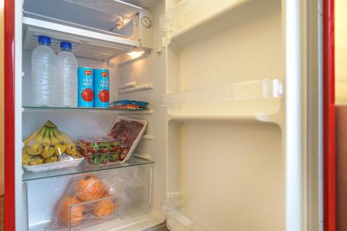 an open refrigerator filled with lots of food and drinks at Hotel Yaja Pyeongtaek St in Pyeongtaek