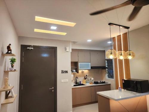 a kitchen with a black door and a counter at UKM Bangi Wonderland 3BR 2bath 2parking in Kampong Tangkas