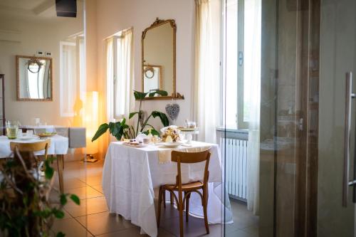 a dining room with two tables and a mirror at Hotel Panorama in Bertinoro