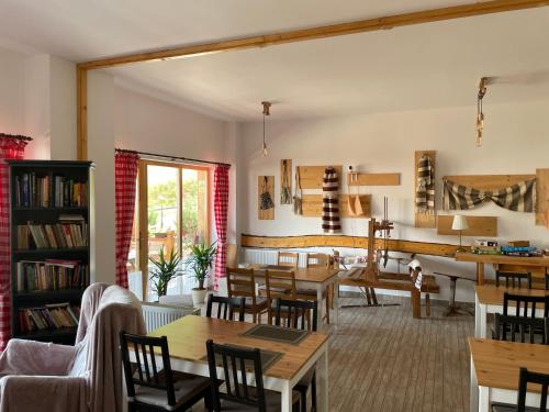 a living room with wooden tables and chairs at Andolia in Moieciu de Sus
