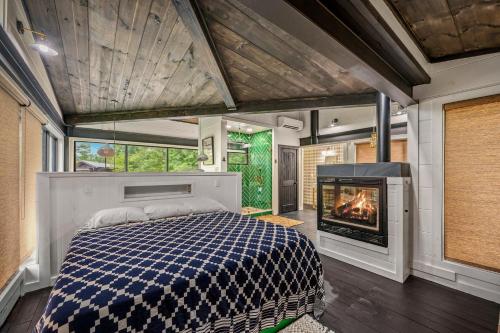 a master bedroom with a bed and a fireplace at Sugar Plum Pines in Gatlinburg