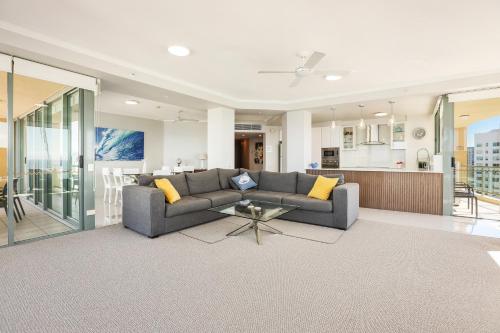 a living room with a couch and a table at Sun City Resort managed by Gchs in Gold Coast