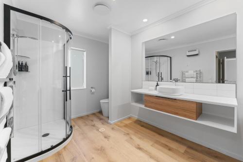a bathroom with a glass shower and a sink at Haven at the Heights - Taupo in Taupo