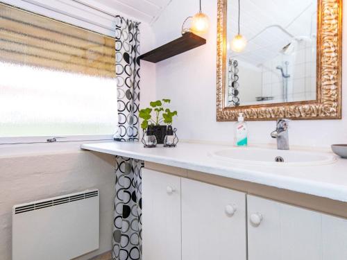 a bathroom with a sink and a mirror at Holiday home Hemmet LI in Hemmet