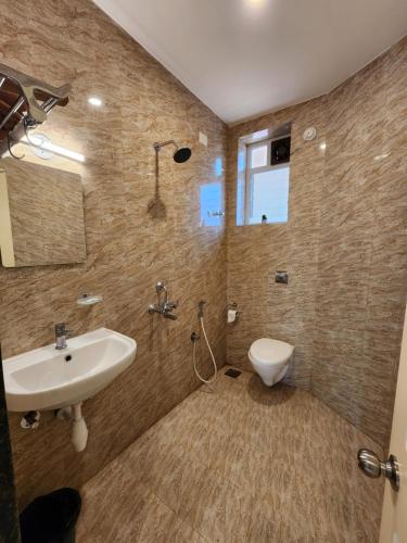 a bathroom with a sink and a toilet at The Regal Luxury Boutique Stays in Majorda