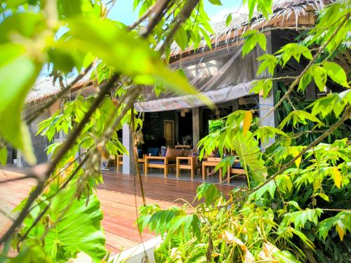 a view of a house through the trees at The Ohm Siargao Resort in General Luna