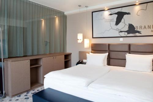a hotel room with two beds and a tv at Holiday Inn Berlin City East Side by IHG in Berlin