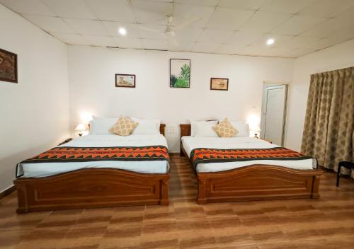 Un ou plusieurs lits dans un hébergement de l'établissement Ibex Resorts, Valparai Mistly