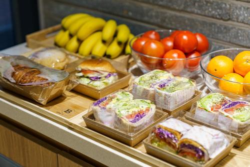 a buffet filled with different types of sandwiches and fruit at Brown Dot Hotel Geumchon in Paju