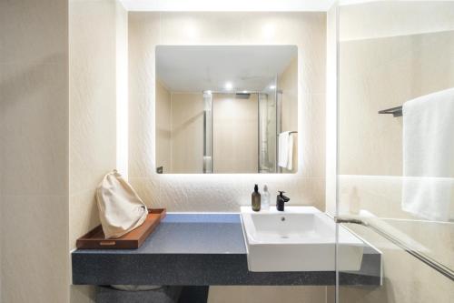 a bathroom with a sink and a mirror at Urbanstay Siheung Geobukseom in Siheung