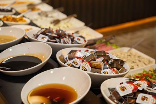 a table topped with bowls of food and cups of tea at Boris Hotel Beylikdüzü in Beylikduzu