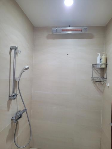 a bathroom with a shower with a shower head at The Delice house near Train street, old Quarter in Hanoi