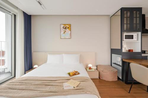 a bedroom with a large bed and a desk at Urbanstay Siheung Geobukseom in Siheung