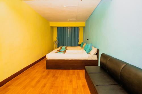 a room with a bed and a couch in it at Rest Up Thamel Hostel in Kathmandu