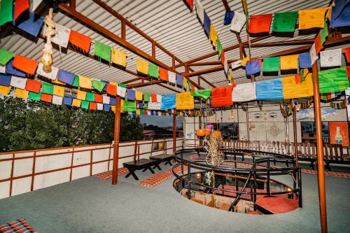 a room with colorful flags hanging from a roof at Rest Up Thamel Hostel in Kathmandu