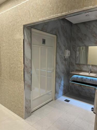 a bathroom with a shower and a sink at Binayat Hama Serviced Apartments - Standard in Al Jubail