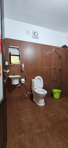 a bathroom with a toilet and a sink at CASA DE CANOLI - A Private backwater villa in Kodungallūr