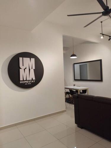 a room with a sign on a wall with a table at UMMA Homestay Jitra in Jitra