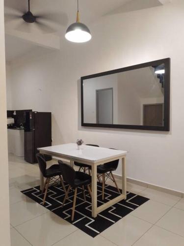 a dining room table with chairs and a mirror at UMMA Homestay Jitra in Jitra
