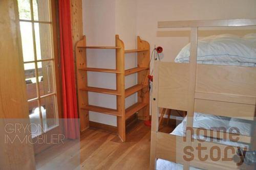 a dorm room with a bunk bed and a ladder at Dauphinelles 09 in Gryon