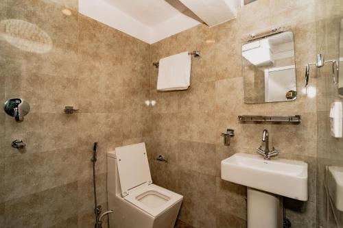 a bathroom with a toilet and a sink at Rest Up Thamel Hostel in Kathmandu