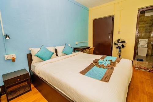 a bedroom with a large bed with a blue wall at Rest Up Thamel Hostel in Kathmandu