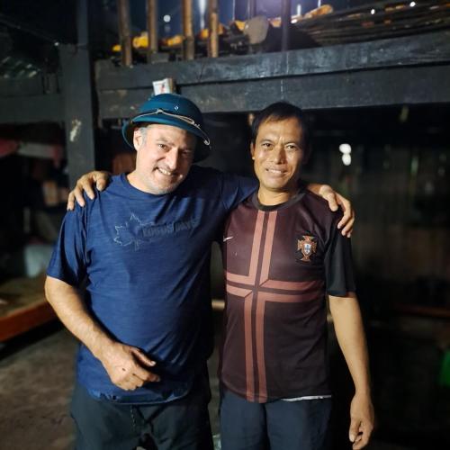 two men are standing next to each other at Homestay field - bungalow, Ha giang loop tour, motorbikes rental in Ha Giang