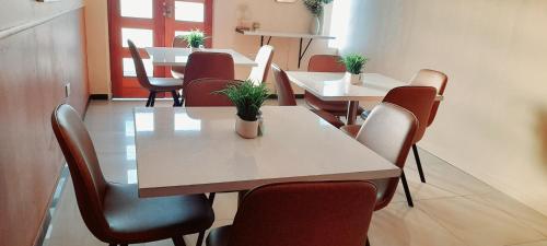 a dining room with a table and chairs at Rest & Digest in Serowe