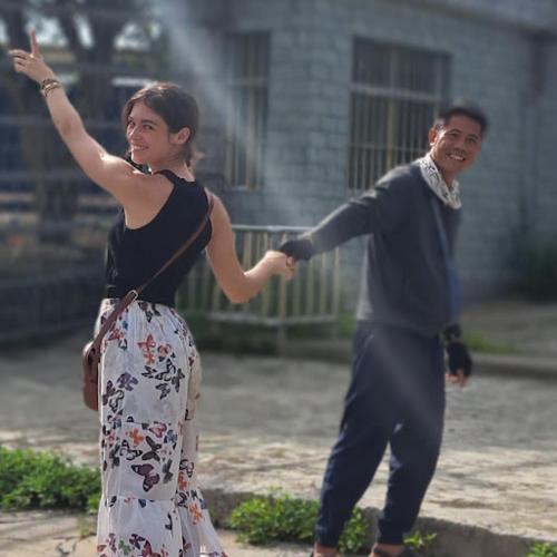 a man and a woman are playing with a fountain at Homestay field - bungalow, Ha giang loop tour, motorbikes rental in Ha Giang