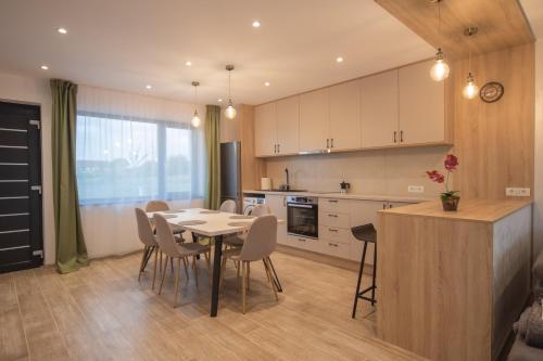 a kitchen and dining room with a table and chairs at CP Residence Apart in Braşov